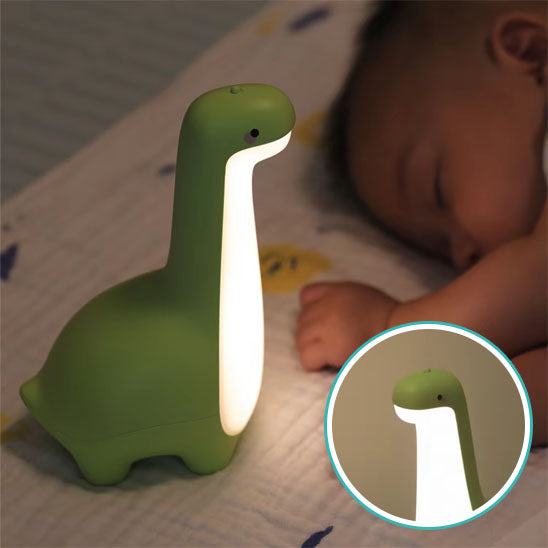Enfant dormant à côté d'une veilleuse dinosaure sécurisée-sphere de maman-nourrison