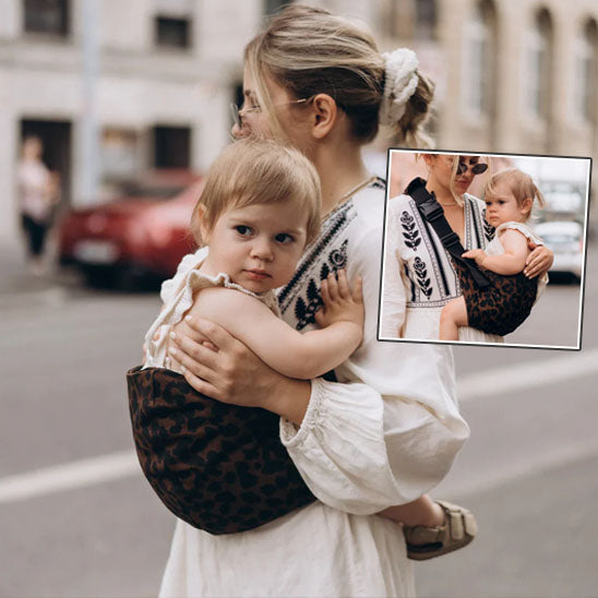 Photo d’un porte-bébé multifonction léopard porté en promenade, parfait pour le confort des parents-sphere de maman-nourrison
