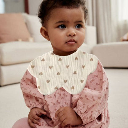 Bavoir bébé en coton confortables et imprimés avec motifs délicats pour protéger les vêtements.